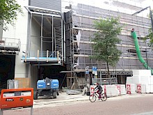 The structure of the curtain wall of the extension is placed. Existing façade still hidden by scaffolding.