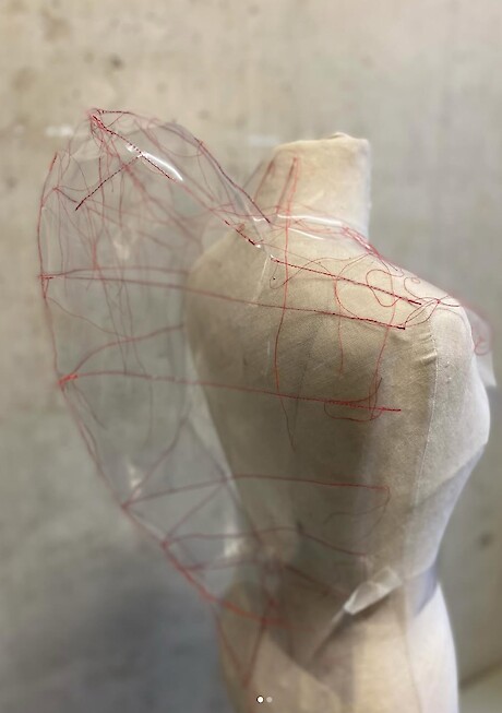 Plastic sewn with red thread
shape created using a moulding technique